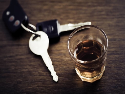 car keys next to a shot of alcohol